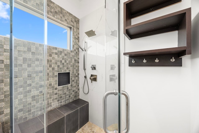 bathroom featuring a shower with door