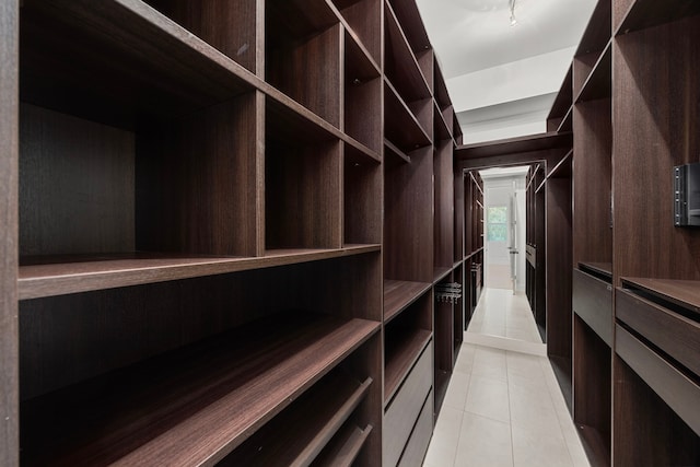 spacious closet with light tile patterned floors