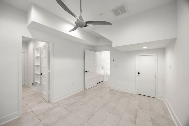 unfurnished bedroom with light tile patterned floors and ceiling fan