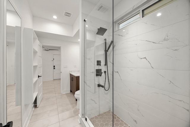 bathroom with toilet, vanity, and tiled shower