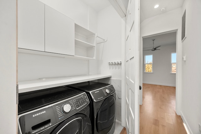 clothes washing area featuring independent washer and dryer, ceiling fan, and light wood-type flooring