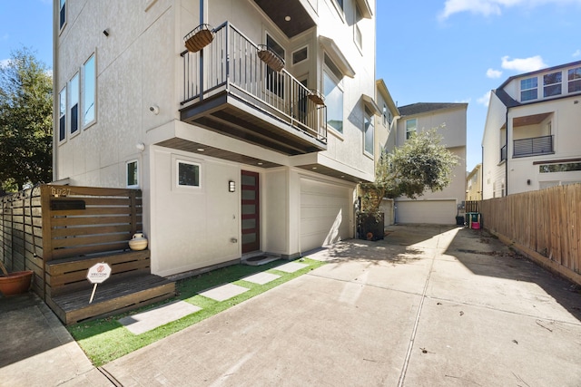 exterior space featuring a garage and a balcony