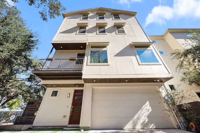 view of front of property with a garage and a balcony