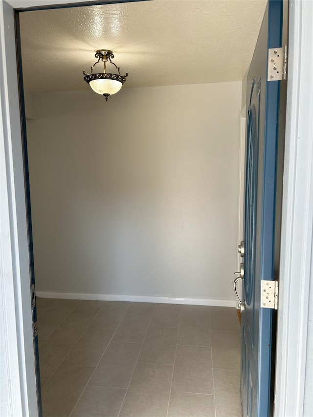 interior space with tile patterned flooring and a textured ceiling