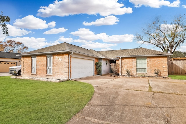 ranch-style house featuring a front lawn and a garage