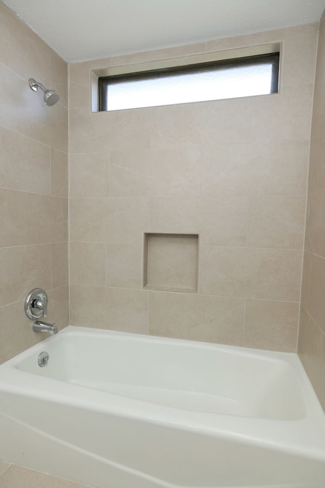 bathroom featuring tiled shower / bath combo and tile patterned floors