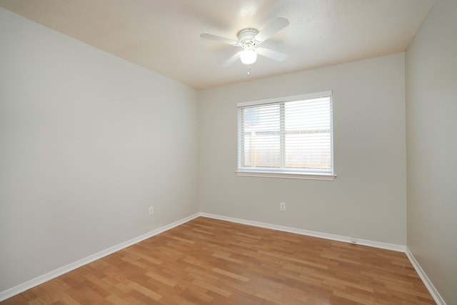 spare room with ceiling fan and light wood-type flooring