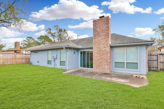 rear view of house featuring a patio area and a yard