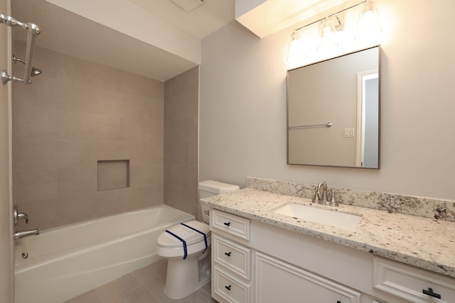 full bathroom featuring toilet, tiled shower / bath combo, vanity, and tile patterned floors