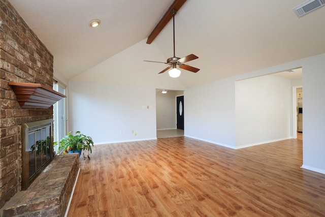 unfurnished living room with light hardwood / wood-style floors, vaulted ceiling with beams, ceiling fan, and a fireplace