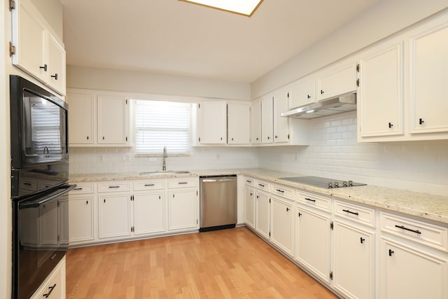 kitchen featuring black appliances, sink, white cabinetry, and light hardwood / wood-style flooring