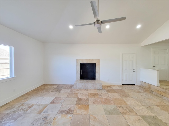 unfurnished living room with ceiling fan, a fireplace, and lofted ceiling