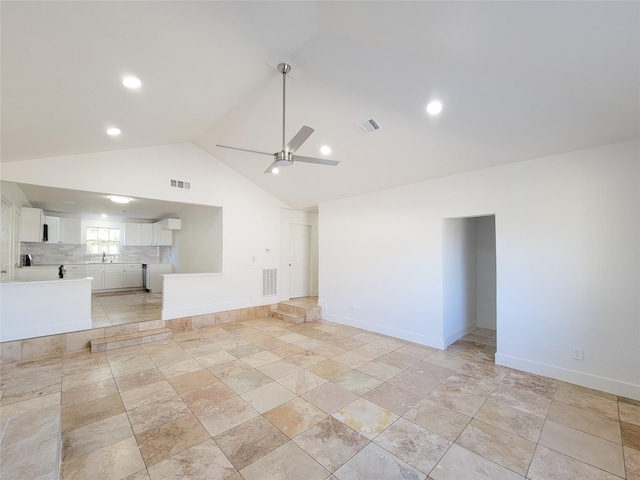 spare room featuring ceiling fan, sink, and high vaulted ceiling