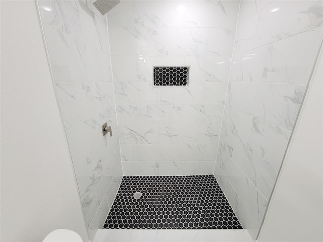 bathroom with a tile shower