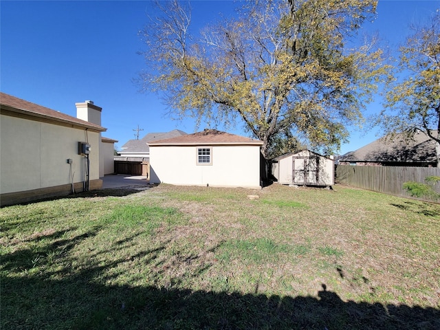 view of yard featuring a storage unit and a patio area