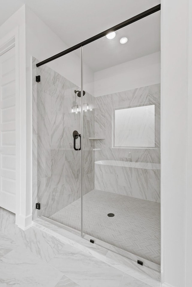 bathroom featuring a shower with shower door