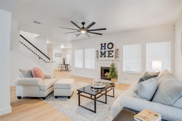 living room with ceiling fan and light wood-type flooring