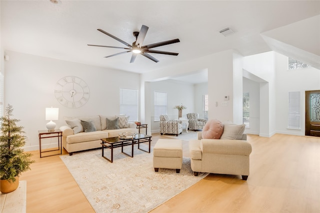 living room with ceiling fan and light wood-type flooring