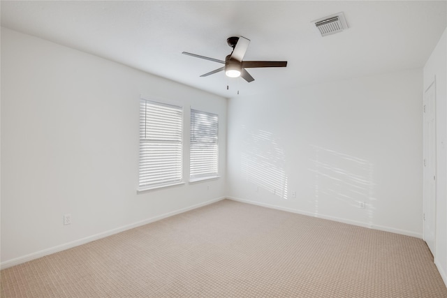 unfurnished room with ceiling fan and light carpet