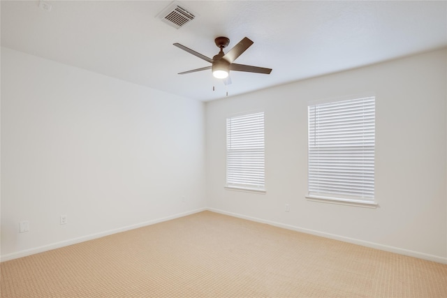 spare room featuring ceiling fan and light colored carpet