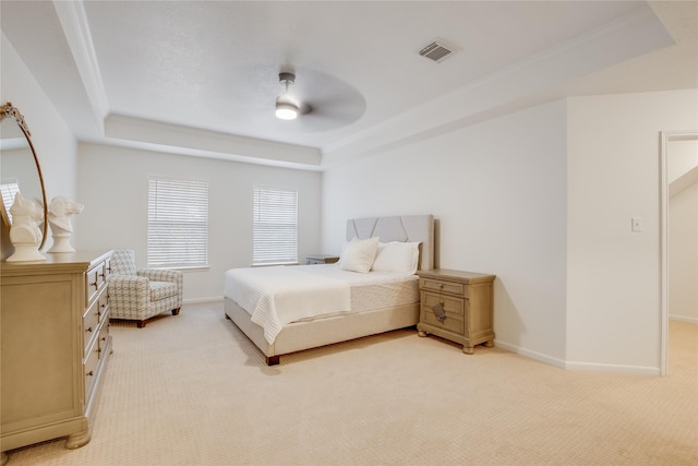 carpeted bedroom featuring a raised ceiling, ceiling fan, and ornamental molding