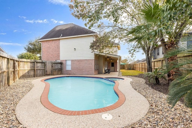 view of pool with a patio and ceiling fan