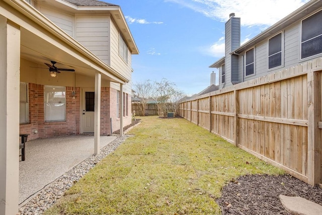 view of yard with ceiling fan and a patio area