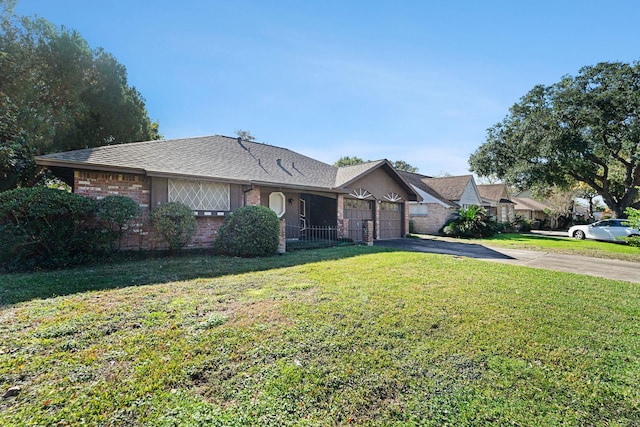 ranch-style home featuring a garage and a front lawn