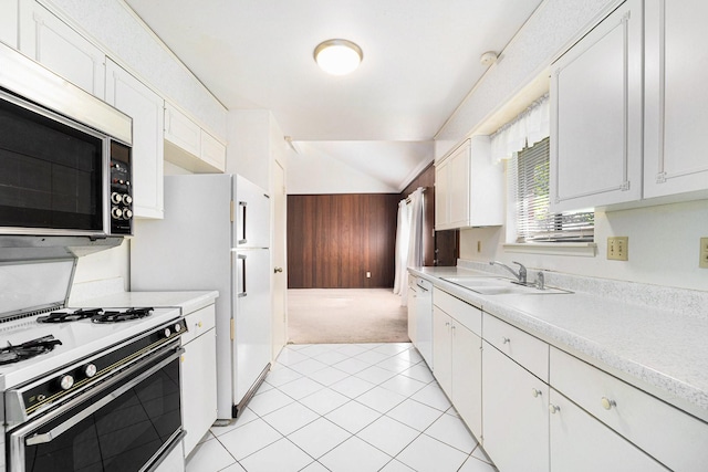 kitchen with stainless steel microwave, light countertops, white range with gas stovetop, and a sink