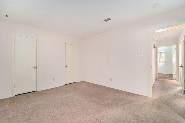 empty room with light colored carpet