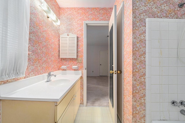 full bath with wallpapered walls and vanity