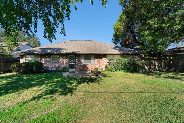 rear view of house featuring a lawn