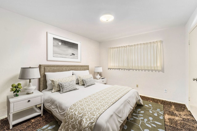 carpeted bedroom featuring baseboards