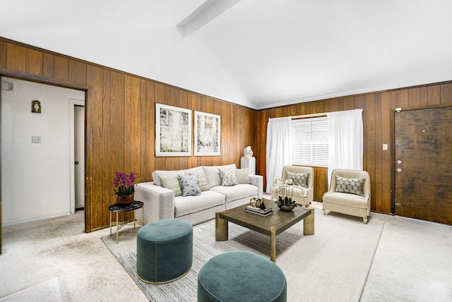 living area featuring light carpet, high vaulted ceiling, beam ceiling, and wood walls