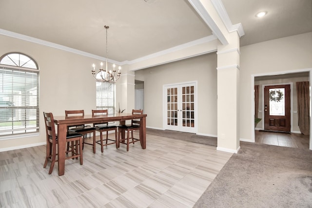 dining space featuring plenty of natural light, crown molding, and an inviting chandelier