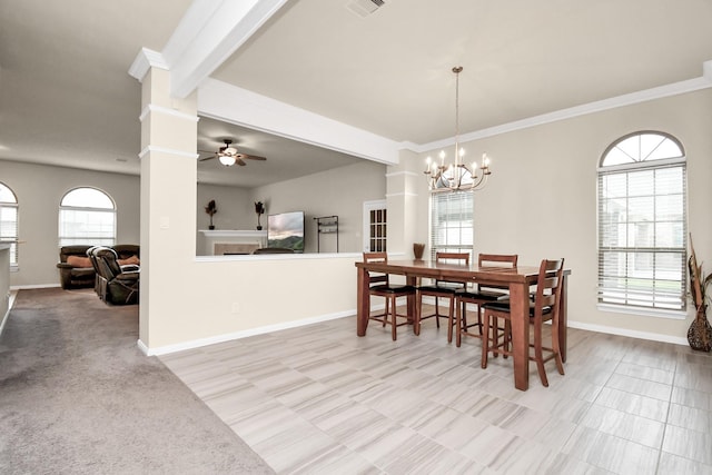 dining space featuring a wealth of natural light, light carpet, and ceiling fan with notable chandelier