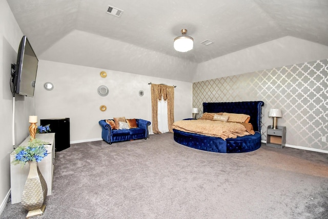 carpeted bedroom with lofted ceiling