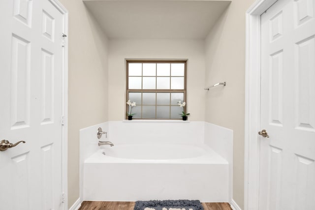 bathroom featuring hardwood / wood-style floors and a tub