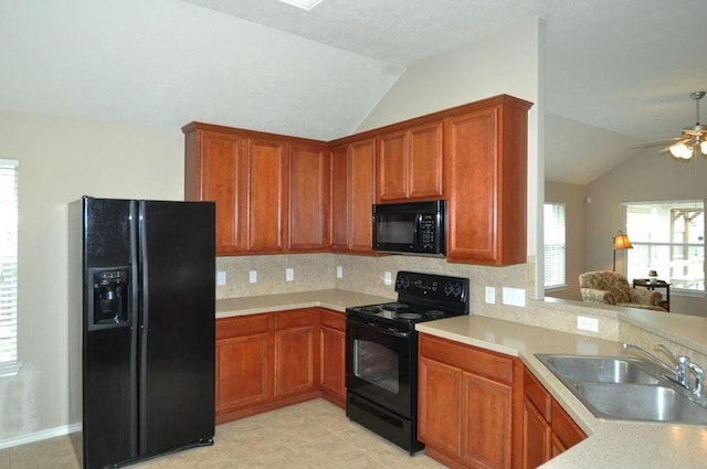 kitchen with black appliances, sink, vaulted ceiling, ceiling fan, and tasteful backsplash