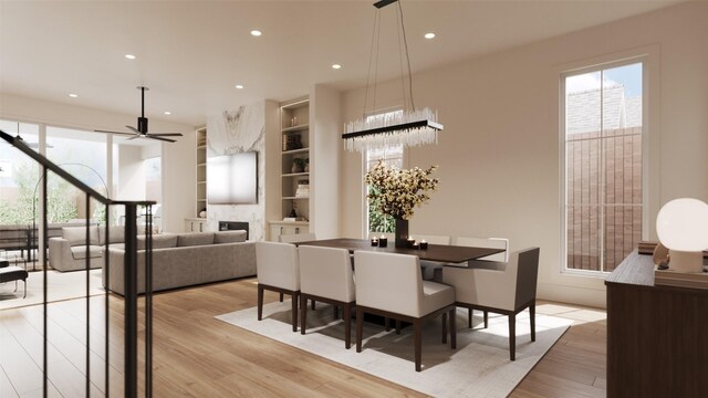 dining area with built in shelves, ceiling fan, and light hardwood / wood-style flooring