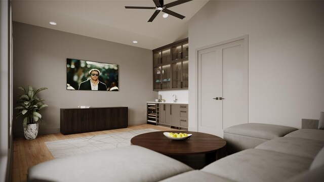 living room featuring light wood-type flooring, vaulted ceiling, ceiling fan, wet bar, and wine cooler