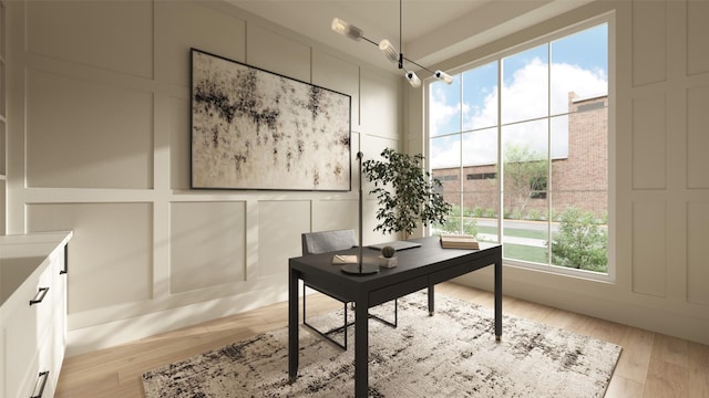 office area featuring a decorative wall and light wood-style flooring