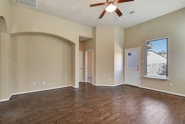 spare room featuring dark hardwood / wood-style flooring and ceiling fan