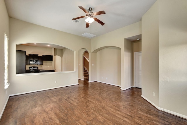 unfurnished living room with ceiling fan and dark wood-type flooring