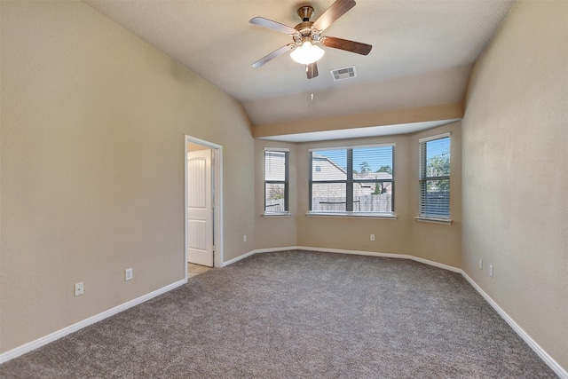 spare room with carpet flooring, plenty of natural light, and lofted ceiling