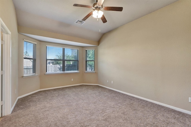 carpeted empty room featuring ceiling fan and vaulted ceiling