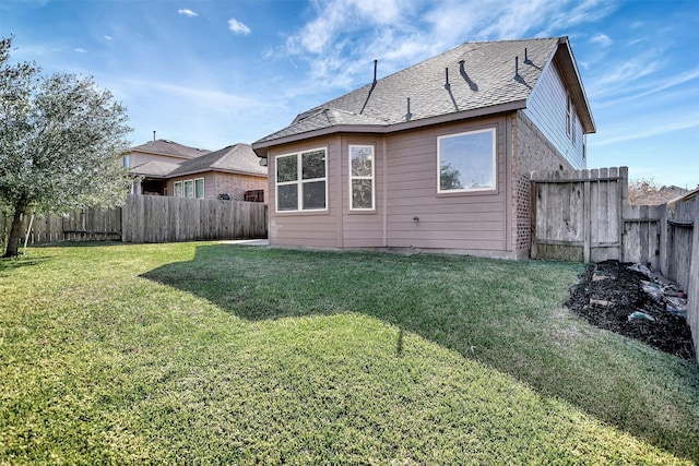 rear view of property featuring a lawn