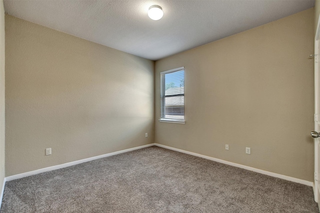 carpeted empty room with a textured ceiling