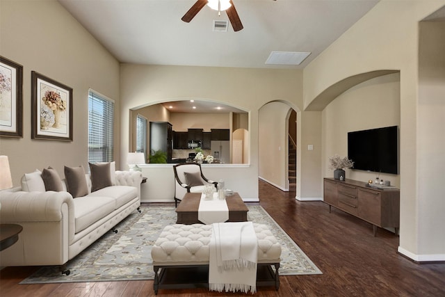 living room featuring ceiling fan and dark hardwood / wood-style flooring