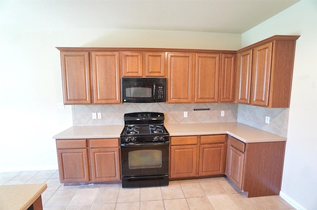 kitchen featuring black appliances, light tile patterned flooring, and backsplash